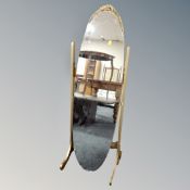 A cheval mirror on gilt stand.