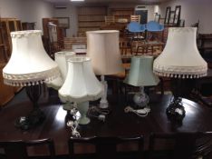A pair of contemporary table lamps with tasseled shades together with four further ceramic table