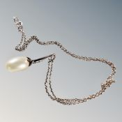A Baroque teardrop pearl in an Art Deco setting on sterling silver chain, 7.9g gross.