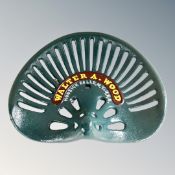 A cast iron Walter A. Wood tractor seat.