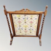 An oak barley twist framed tapestry fire screen