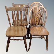 A pair of stained beech Windsor dining chairs together with a further pair of kitchen chairs