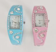 New lady's pink and blue metal watches with diamante quartz crystals together with gold plated box