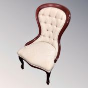 A Victorian style nursing chair in buttoned fabric