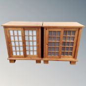 A pair of pine sliding door double door cabinets