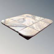 A late 20th century square pedestal coffee table with nine inset granite panels