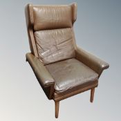 A 20th century Danish brown leather wing backed armchair