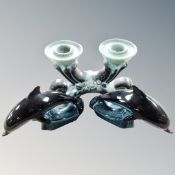 Two Poole pottery dolphins together with a two-way candle holder.