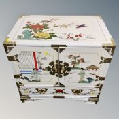 A Japanese style double door low cabinet fitted a drawer and three internal drawers