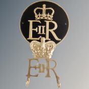 A cast iron Queen Elizabeth wall plaque and two hook wall rack.