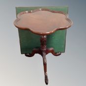 A Victorian style shaped mahogany pedestal wine table on claw and ball feet together with a 20th