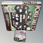 A poker table top together with a further tin of poker chips