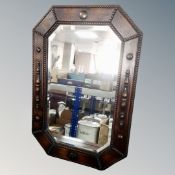 An Edwardian oak octagonal beaded frame mirror.