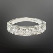 An 18ct white gold seven stone diamond half-eternity ring, the total diamond weight estimated at 1.