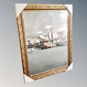 A decorative gilt framed bevel edged mirror.