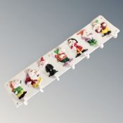 A cast iron Seven Dwarves seven hook wall rack.