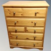 A Goldpine furniture Ltd pine six drawer chest with brass handles