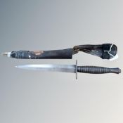 A Fairbairn Sykes 3rd pattern commando knife in sheath CONDITION REPORT: Sheath in