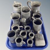 A tray of antique pewter tankards and measures, pepper pot,