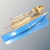 A vintage wooden pond yacht with sails,