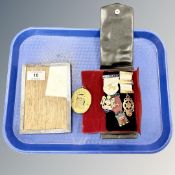 A silver photo frame and a small group of Masonic medals.
