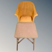 A 20th century painted Lloyd loom armchair together with similar occasional table