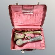 A red case containing vintage brass air horns