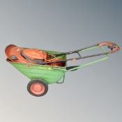 A Flymo Turbo Lite 330 electric lawn mower together with a Portrax wheel barrow