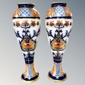 A pair of Macintyre Burslem Imari porcelain vases, height 29cm.