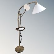 A floor standing angle poise lamp with magnifier