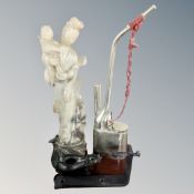 A Japanese carved polished stone figure together with an opium pipe and metal incense burner