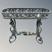 A wrought metal plant trough on raised legs