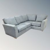 A Marks and Spencer four seater corner settee in turquoise fabric