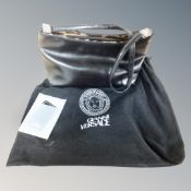 A Gianni Versace bag with dust protector and original tags (handle a/f)