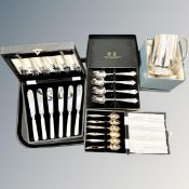 A tray of three boxed cutlery sets and a silver-plated tankard.