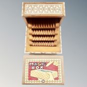 A 20th century wooden musical concertina cigarette box with mother of pearl inlay together with