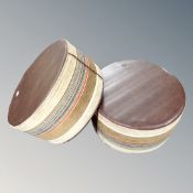 A pair of circular fabric footstools