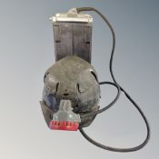 A vintage coal miner's helmet with lamp and battery pack
