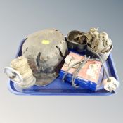 A vintage miner's helmet with carbide lamp Oldham charger and face mask in metal tin
