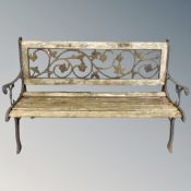 A wrought iron wooden slatted garden bench