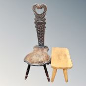 A carved oak spinning chair together with a further footstool