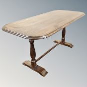 A beech refectory dining table together with a set of four wheel backed chairs