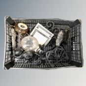 A crate of metal ware, cast iron cat door stop, iron trivet, photograph frames,