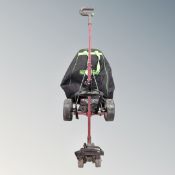 A Hill Billy electric golf cart with battery and charger in carry bag