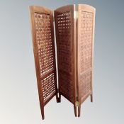 A contemporary lattice panel three-way folding screen