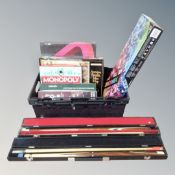 A crate of board games, snooker cues in case,