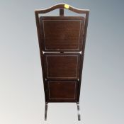 An Edwardian mahogany three tier folding cake stand