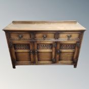 A 20th century triple door sideboard with three drawers CONDITION REPORT: