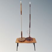 A mid century coffee table on legs together with two mid century standard lamps