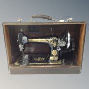 A vintage Singer hand sewing machine in case